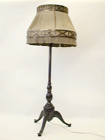 Stehlampe, 30er J., dicke Säule, Dreibein, Bronze verziert, Faltenschirm beige mit Goldbordüre