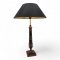 Tischlampe, Holz schwarz, Säule mit goldenen Lorbeeren verziert, Sockel viereckig, gestuft, 1 flg. E27 max.60W, H63